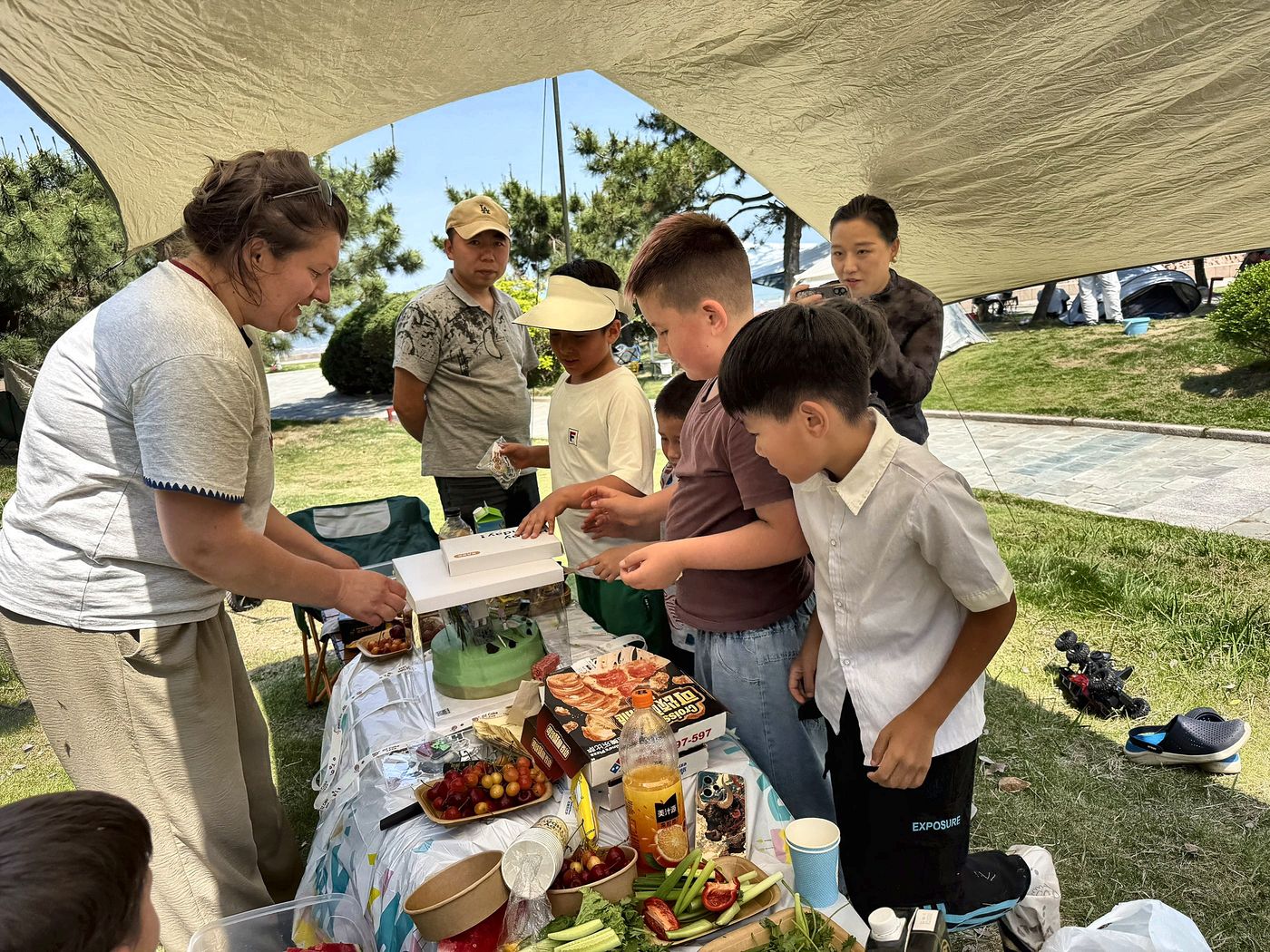 Cutting cake at a seaside picnic
